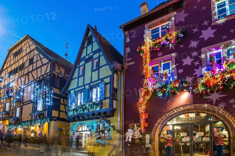 Colour-illuminated and Christmassy decorated half-timbered houses, blue hour, Christmas market, Riquewihr, Grand Est, Haut-Rhin, Alsace, France