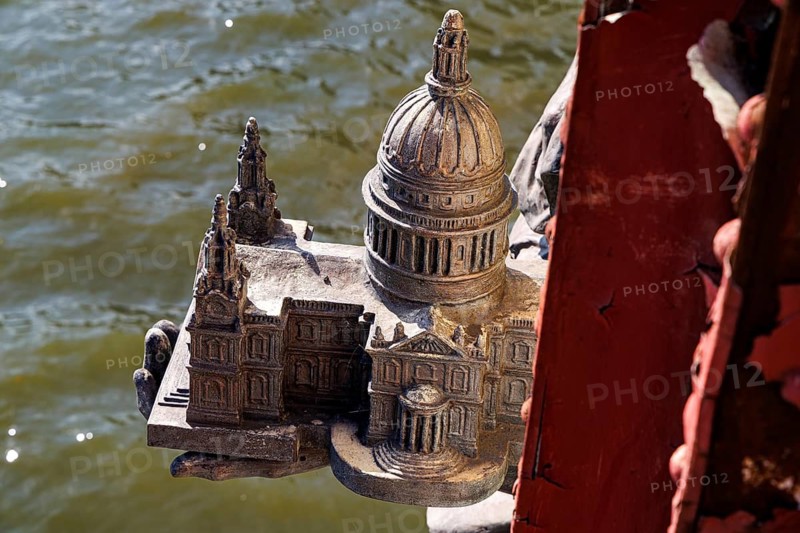 Secret London. An intricately cast miniature of St Paul's Cathedral rests in the hand of the bronze figure of Architecture on Vauxhall Bridge, over the River Thames, one of eight allegorical statues added by sculptor F. W. Pomeroy and Alfred Drury around 1907 to decorate the bridge completed in 1906. London, England, United Kingdom