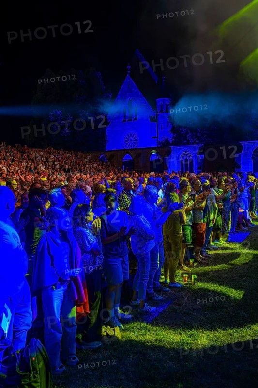 Open-air concert at night with blue lighting and Gothic architecture in the background, Calwer Klostersommer Festival, Hirsau Abbey, Calw, Germany