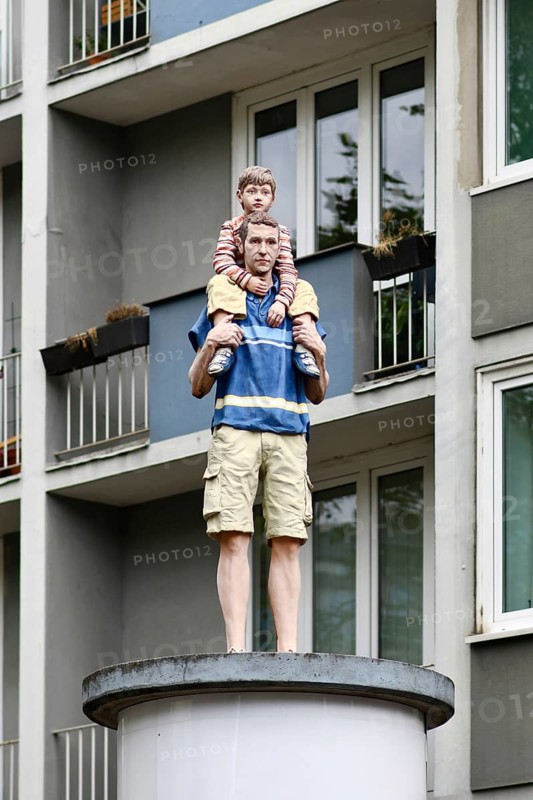 Düsseldorf, Germany - June 9th 2026: Colored modern Vater und Sohn sculpture in Dusseldorf. Bronze father and son statue at Immermannstraße and Oststraße street intersection as urban public art