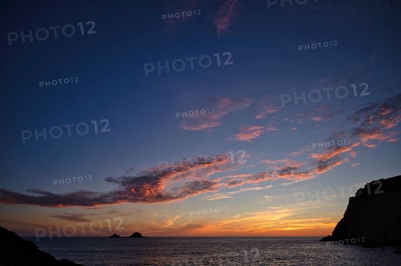 Sunset, sunset at sea, dramatic clouds, in the background rock formation The Brisons, Cot Valley Beach, Porth Nanven, coast, St Just in Penwith, Cornwall, England, Great Britain, Great Britain