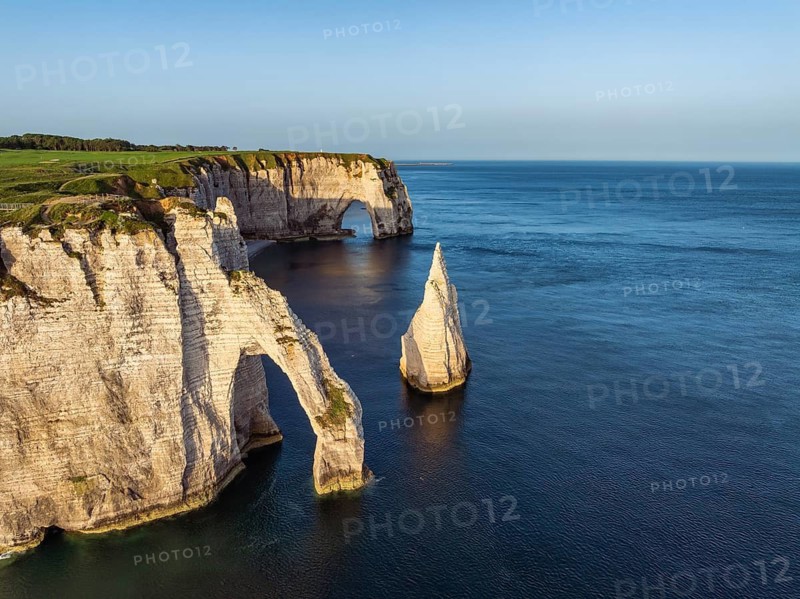 Aerial view of the Porte d'Aval rock formation with the free-standing Aiguille d'Étretat rock pin in the morning sun, well-known sights and natural beauty on the chalk coast with the distinctive rock pin, behind it the La Manneporte rock gate, Étretat, Alabaster Coast, La Côte d'Albâtre, chalk cliffs, English Channel, Seine-Maritime, Normandy, France