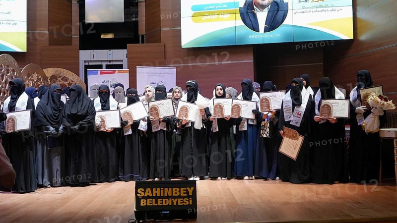 Gaziantep, Turkey - August 19, 2026: Women wearing niqabs receive their graduation certificates for successfully memorizing the Holy Quran during a ceremony honoring memorizers in Gaziantep in the presence of their families and community members, Gaziantep, Turkey
