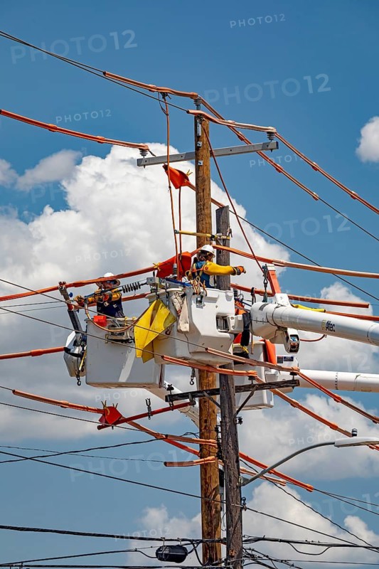 Tulsa, Oklahoma - Workers repair power lines on an electrical pole