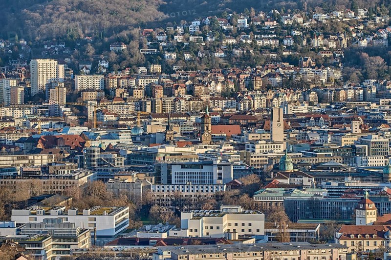 Panoramic view of Stuttgart city center in Germany during spring with warm golden evening light. Dense urban architecture, hills and residential districts captured from an elevated viewpoint, Stuttgart, Baden-Wuerttemberg, Germany