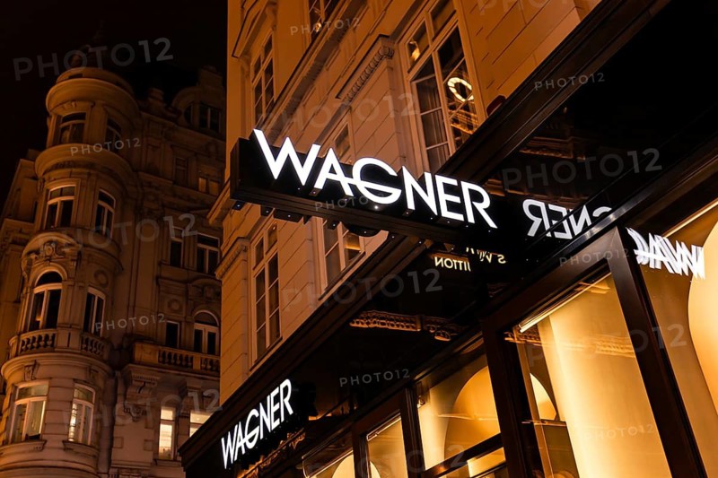 Vienna, Austria - 15 December, 2025: Wagner store front in Vienna, Austria. The illuminated sign displays the brand name prominently against a stylish background