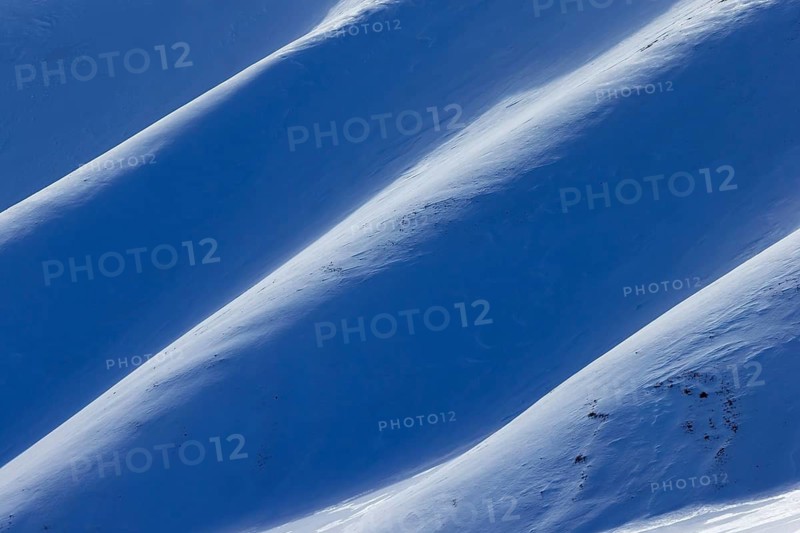 Snow covered mountain slope in Arctic landscape at Mohnbukta, bay at the western shore of Storfjorden in Sabine Land at Spitsbergen, Svalbard
