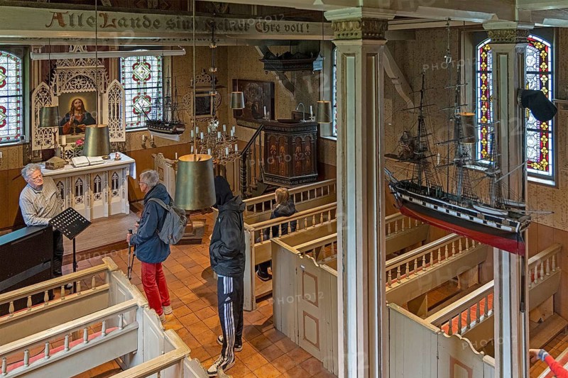 Interior view, visitor, pastor, Old Island Church, Spiekeroog, East Frisia, Lower Saxony, Germany