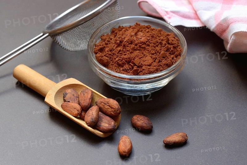 Cocoa powder in glass shell and cocoa beans