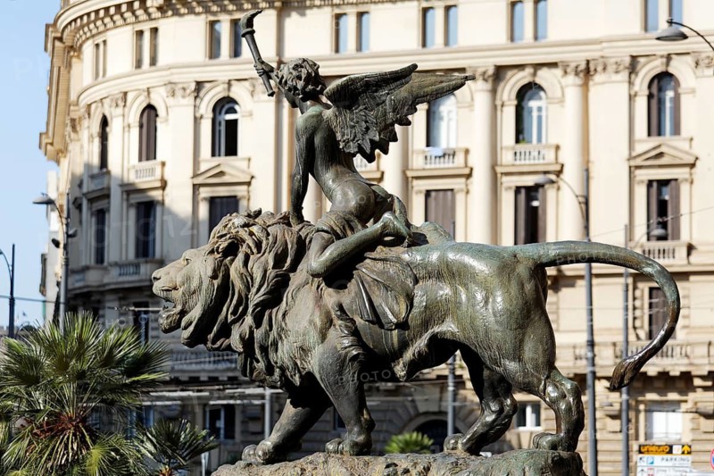 Winged boy riding on a lion, allegorical bronze sculpture in front of the Palazzo della Borsa, Piazza Giovanni Bovio, Naples, Province of Campania, Italy