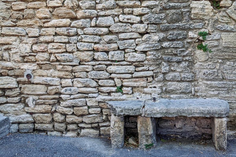 Old stone bench in front of a sandstone wall, Provence, France