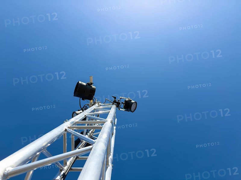 Light tower made of aluminum trusses with mounted LED spotlights against a blue sky, Berlin, Germany