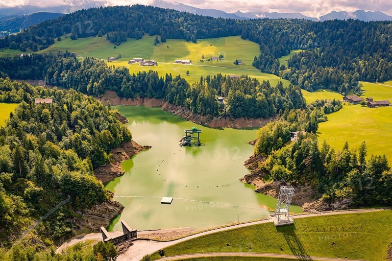 A wide view of hills and green forests under a cloudy sky, Krumbach, Vorarlberg, Austria