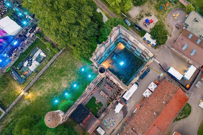 View from above of a festival area with historic buildings at night, Calwer Klostersommer Festival, Hirsau Abbey, Calw, Black Forest, Germany