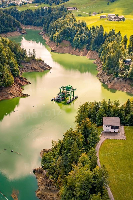 An idyllic river snakes through a green landscape full of trees, Krumbach, Vorarlberg, Austria