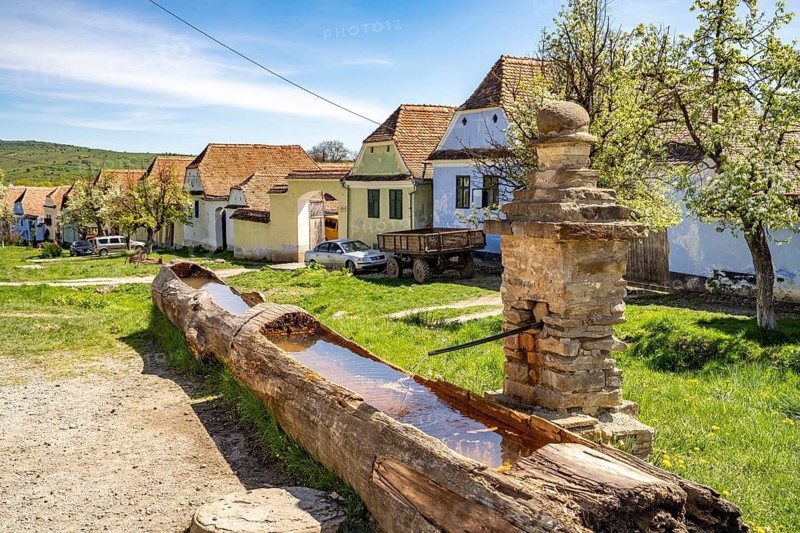 Wooden fountains and traditional Transylvanian-Saxon farms in Viscri or Deutsch-Weisskirch, Transylvania, Romania