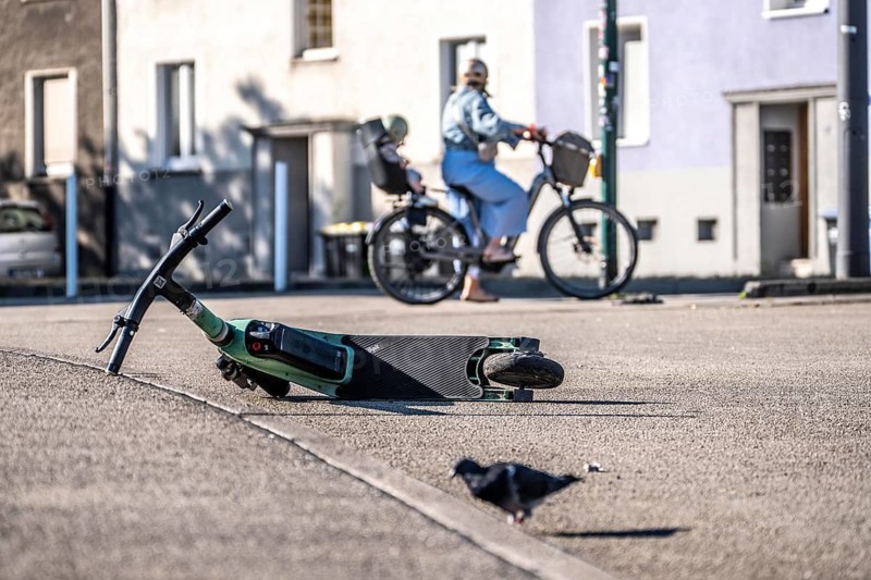 Rental scooter, e-scooter, left at the sidewalk, in Essen, North Rhine-Westphalia, Germany