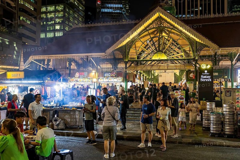 Crowds gather at Satay Street night market beside the Victorian cast iron Lau Pa Sat market building, Singapore