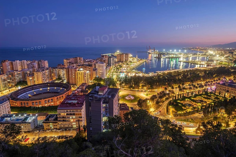 Blue hour view of Plaza de Toros de La Malagueta Bullring in Malaga, Spain, showing port of malaga, la malagueta bullring, la malagueta, plaza de toros, and waterfront