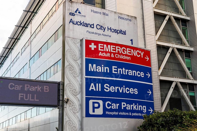Auckland City Hospital entrance signage with Emergency and wayfinding directions, bilingual Maori and English text, Auckland, New Zealand