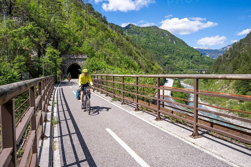 Two cyclists with panniers on a cycle path, cycle path along the old Pontebba railway line in the Canal Valley, Alpe-Adria cycle path, bike packing, Friuli-Venezia Giulia, Italy