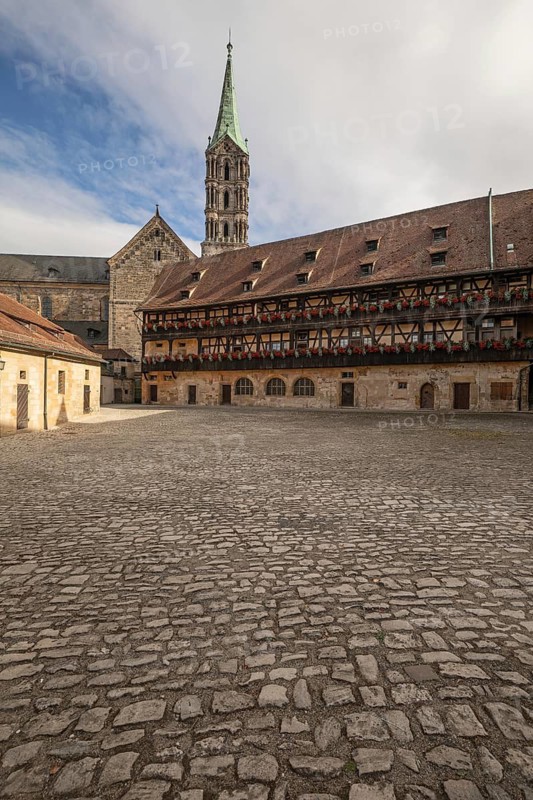 20 August 2026, The historic cobblestone courtyard of Alte Hofhaltung with the Bamberg Cathedral spire visible in Bamberg, Germany