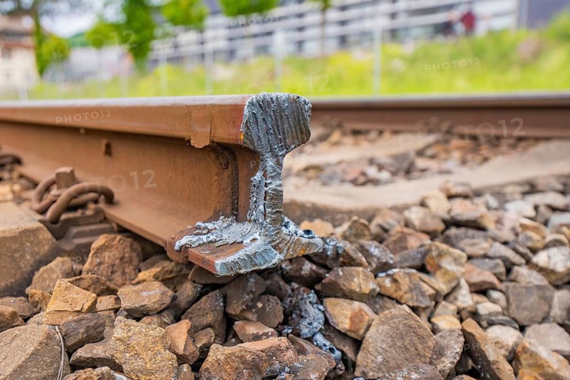 Detailed view of a railroad track with weld and surrounding ballast, Leonhard Weiß electrification station conversion, Waldshut. germany