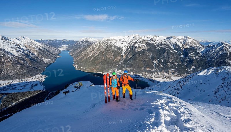 Picturesque view of Achensee and wintry mountain scenery, ski tourers, couple at the summit of Bärenkopf, Achensee, Tyrol, Austria