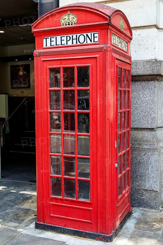 A red K2 telephone kiosk on Kingsway shows the crown motif and glazed panels of Giles Gilbert Scott's 1927 design, one of Britain's best known pieces of street furniture. Its cast iron body established the look of London's red phone boxes. London, England, United Kingdom