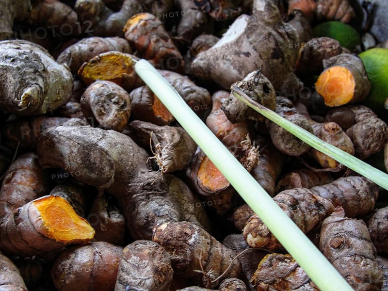 Fresh turmeric root on the market, close-up view, Close-up of turmeric roots with earthy texture highlighting their natural form and colors
