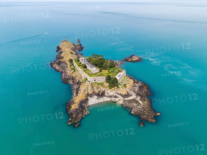 Aerial view of the historic Île des Rimains fortress island with the Fort des Rimains in the turquoise sea. The former lake-fort is located off the coast of the municipality of Cancale, Côte d'Émeraude, Emerald Coast, Ille-et-Vilaine department, Brittany, English Channel, France