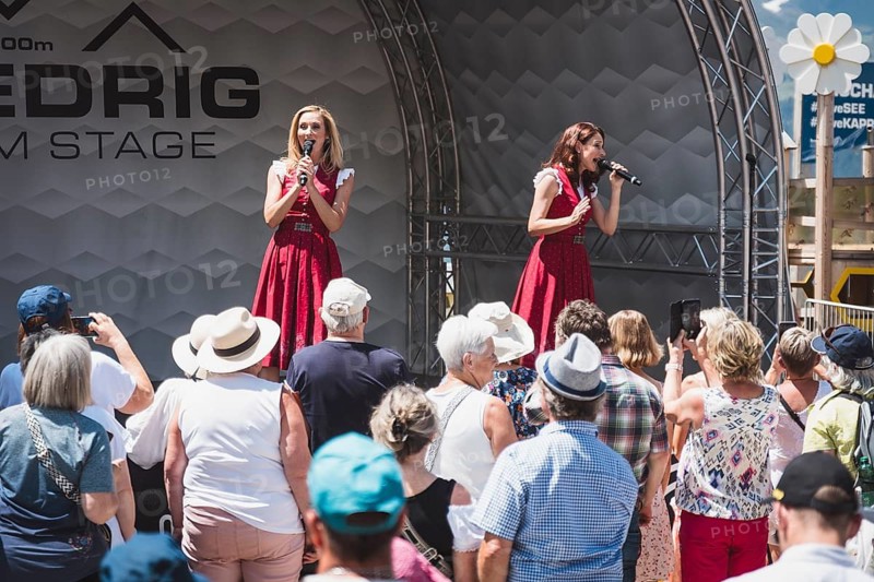 Open-air concert on 27 June 2026 by Sigrid & Marina, supporting Hansi Hinterseer at the Medrig Alm in See in Paznaun Austria to mark the start of the summer season. Around 2, 000 visitors celebrated the start of the Paznaun mountain summer together with locals, families and Schlager fans