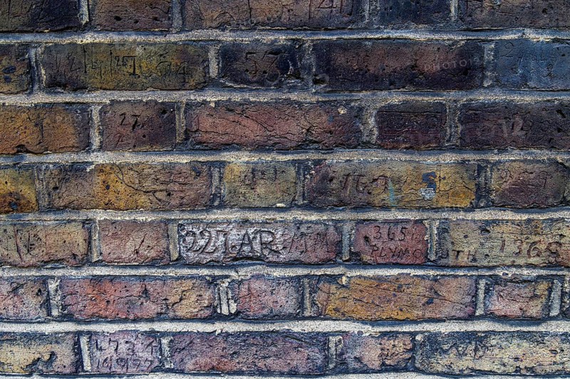 Secret London. A row of carved collar numbers along Myddelton Passage in Clerkenwell includes a numeral followed by the faint word Plymouth, among markings left by nineteenth century Metropolitan Police officers of G Division who patrolled the passage on their beat. London, England, United Kingdom