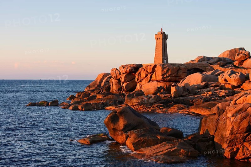 Mean Ruz lighthouse and granite rocks in the evening light, Ploumanac'h, Cote de Granit Rose, Cotes-d'Armor, Brittany, France