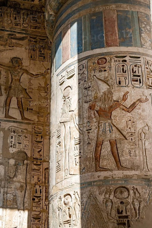 Close up details of the reliefs and hieroglyphs inside Medinat Habu, the ancient Egyptian Mortuary Temple of Ramesses III on the West Bank of The Nile, Luxor, Egypt