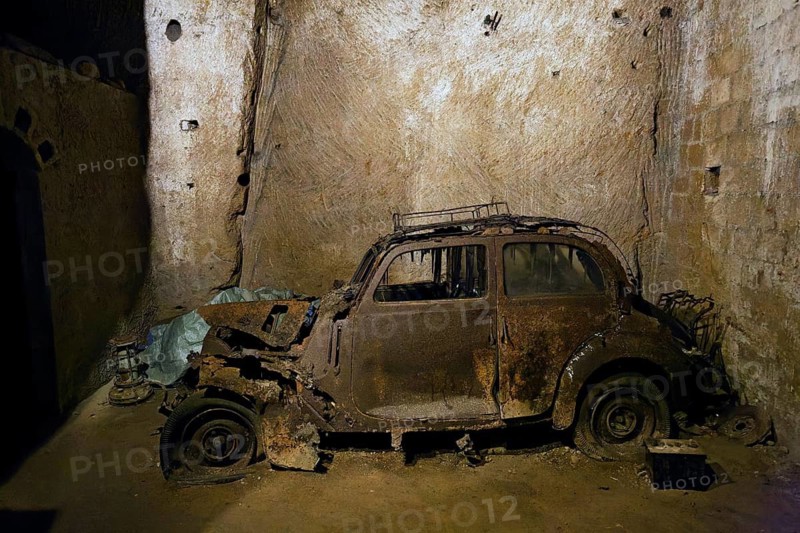 Rotten Lancia Aurelia from the 1950s, car cemetery, Galleria Borbonica, Bourbon Tunnel, underground Naples, Campania province, Italy