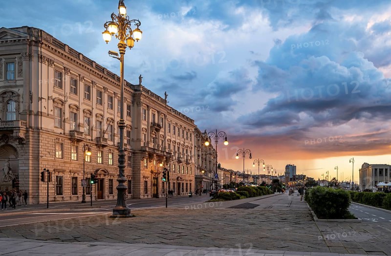 Magnificent Palazzo del Lloyd Triestino on the Riva del Mandracchio seafront, dramatic clouds at sunset, Trieste, Friuli-Venezia Giulia region, Italy