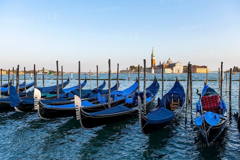 Venetian gondolas, boat launch at St. Mark's Square, San Giorgio Maggiore church in the evening light, Venice, Veneto, Italy