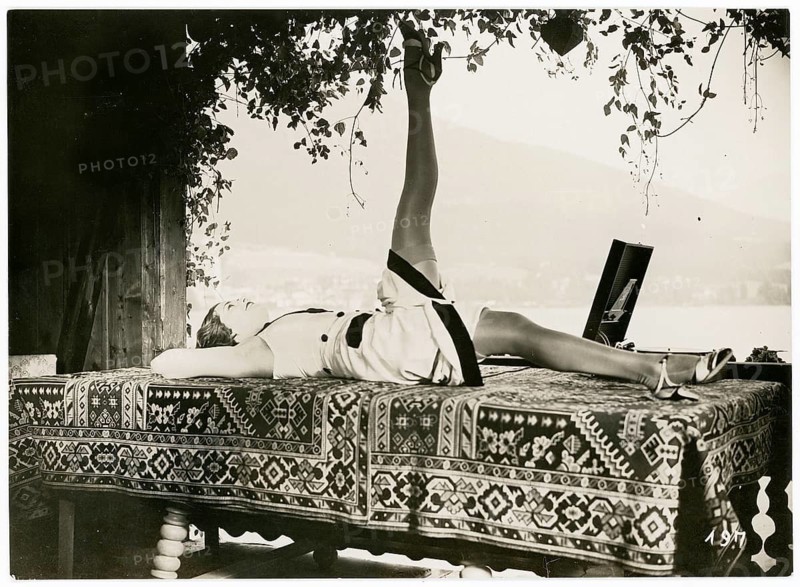 Olga Chekhowa, actress, German, Czech, relaxation, woman relaxing on a couch with raised leg, surrounded by nature and fabric patterns