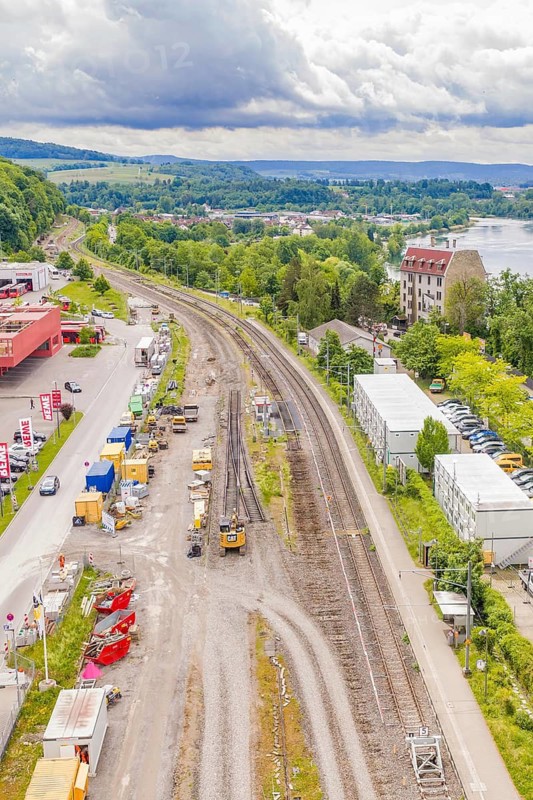 Aerial view of railways and landscape with river, buildings and cloudy sky, Leonhard Weiß electrification station renovation, Waldshut. germany