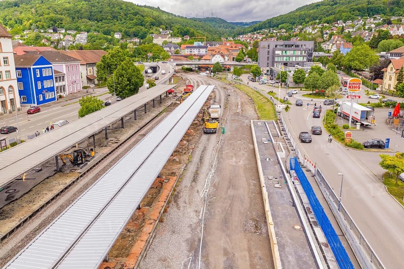 Aerial view of a train station with tracks, buildings, roads and surrounding landscape, Leonhard Weiß electrification station renovation, Waldshut. germany