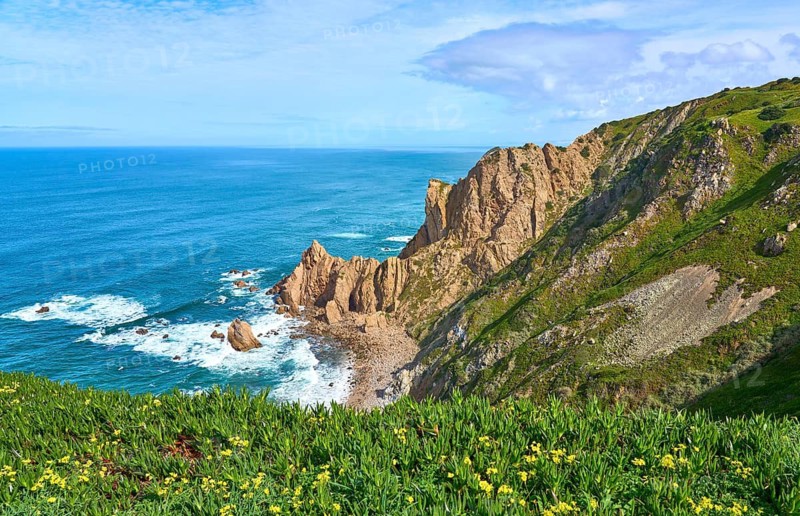 At the rocky and sandy coastline of the atlantic ocean in Porto Covo, Portugal