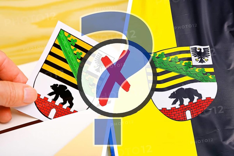 Hand throws the coat of arms of the German federal state of Saxony-Anhalt into a voting box and flag of Saxony-Anhalt with ballot cross and question mark, symbolic photo state election, photo montage +++ editorial use only