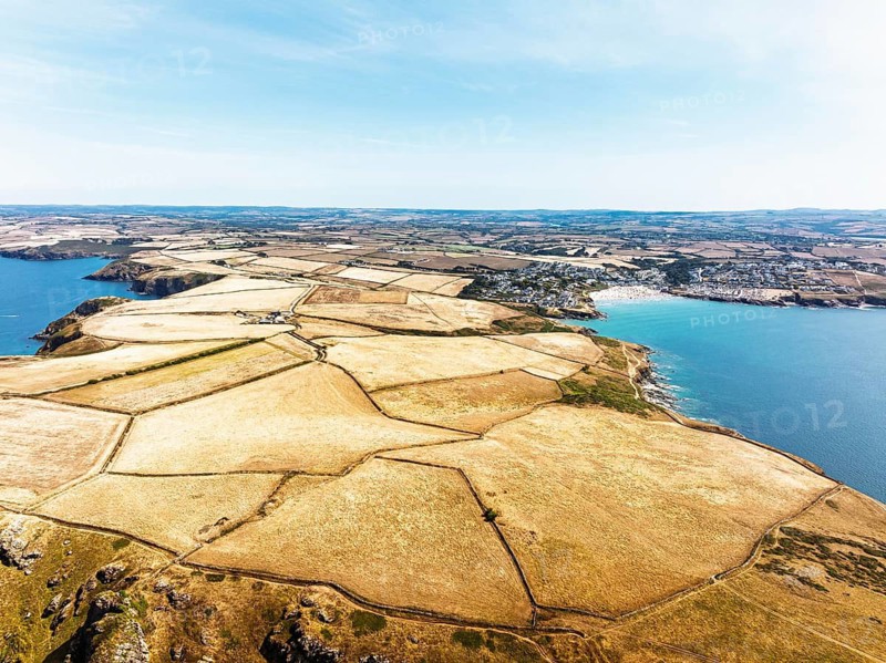 Seven Souls Rock and Pentire Point and Bay over Padstow Bay from a drone, Polzeath, Cornwall, England, Summer 2026