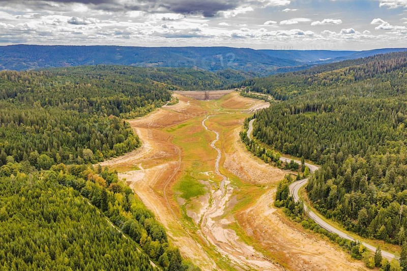 Panorama of a dry riverbed surrounded by forests and hills, rehabilitation of the Schwarzenbach dam, Forbach, Black Forest, Germany