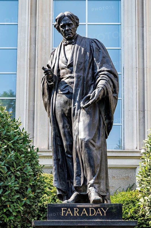 A bronze statue of Michael Faraday stands outside the Institution of Engineering and Technology on Victoria Embankment, commemorating the London born scientist whose pioneering research into electromagnetism and electrochemistry laid the foundations of modern electrical technology. London, England, United Kingdom