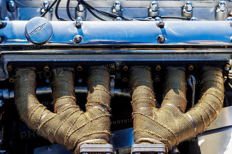 Exhaust manifolds wrapped in heat tape on a classic Jaguar XK straight-six engine