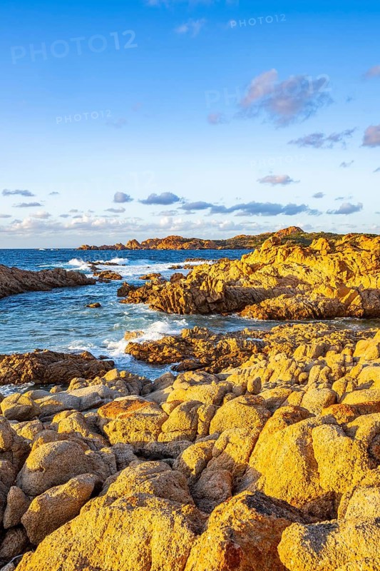 Landscape of the coastline with blue water at Marinedda Coast at sunset, Sardinia, Italy