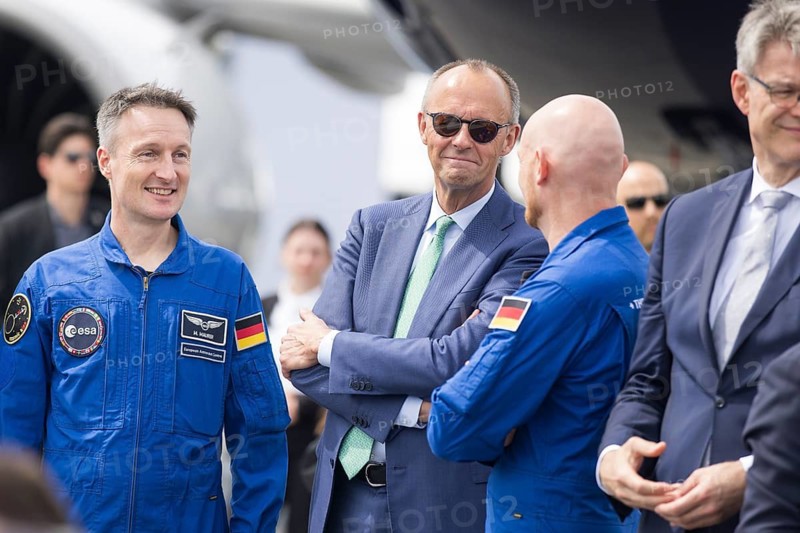 Friedrich Merz (Chancellor of the Federal Republic of Germany, CDU, wearing sunglasses) chats with the two German astronauts Alexander Gerst and Matthias Maurer at the ILA (International Aerospace Exhibition) on 10 June 2026 at the Berlin-Schönefeld Exhibition Centre