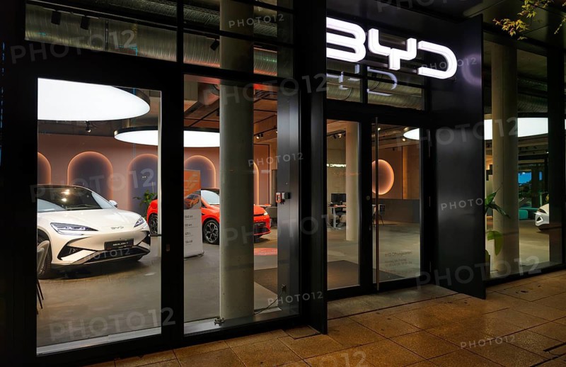 Night shot, view of showroom through shop window, sales exhibition of the car brand BYD Build Your Dreams, logo, e-vehicles, electric vehicles, Stuttgart, Baden-Württemberg, Germany